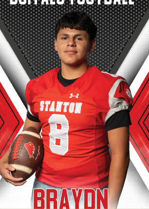 A young man wearing a white and black jersey with the number 14 on it. Description generated by AI