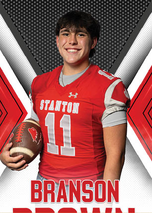 A young man wearing a white and black jersey with the number 14 on it. Description generated by AI