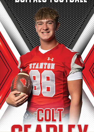A young man wearing a white and black jersey with the number 14 on it. Description generated by AI