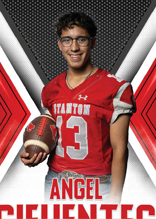 A young man wearing a white and black jersey with the number 14 on it. Description generated by AI