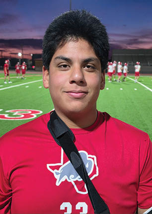 A young man wearing a white and black jersey with the number 14 on it. Description generated by AI