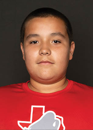 A young man wearing a white and black jersey with the number 14 on it. Description generated by AI