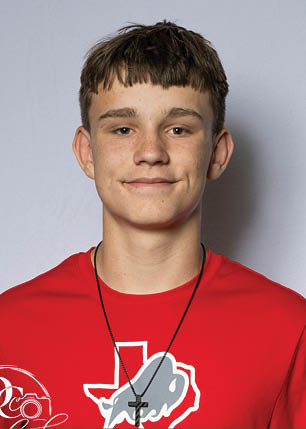 A young man wearing a white and black jersey with the number 14 on it. Description generated by AI