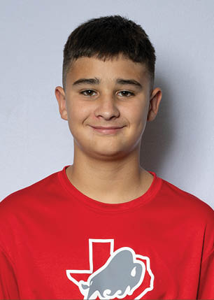 A young man wearing a white and black jersey with the number 14 on it. Description generated by AI