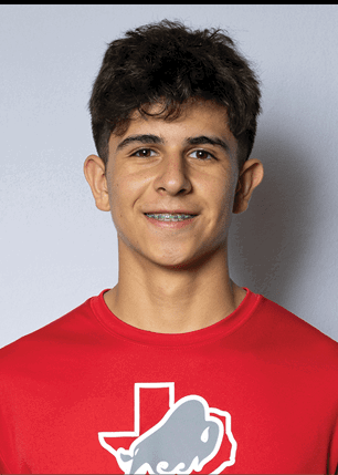 A young man wearing a white and black jersey with the number 14 on it. Description generated by AI