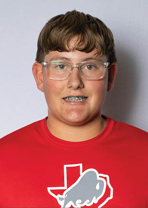 A young man wearing a white and black jersey with the number 14 on it. Description generated by AI