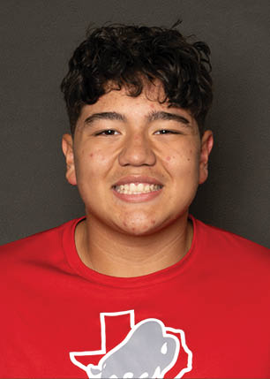 A young man wearing a white and black jersey with the number 14 on it. Description generated by AI