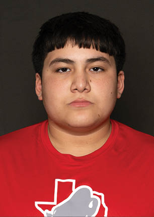 A young man wearing a white and black jersey with the number 14 on it. Description generated by AI