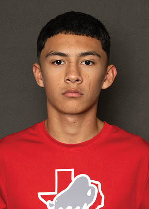 A young man wearing a white and black jersey with the number 14 on it. Description generated by AI
