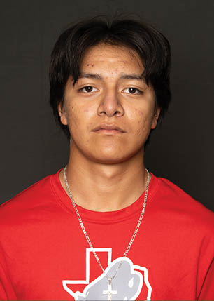 A young man wearing a white and black jersey with the number 14 on it. Description generated by AI
