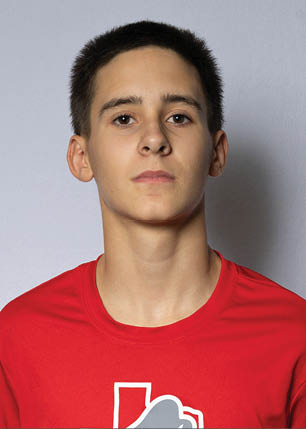 A young man wearing a white and black jersey with the number 14 on it. Description generated by AI