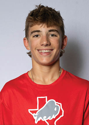 A young man wearing a white and black jersey with the number 14 on it. Description generated by AI