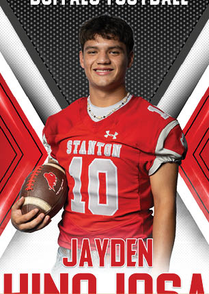 A young man wearing a white and black jersey with the number 14 on it. Description generated by AI