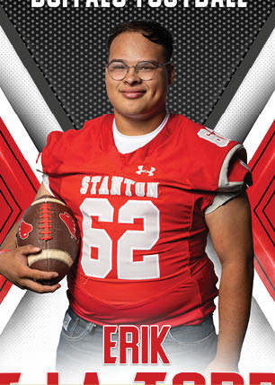 A young man wearing a white and black jersey with the number 14 on it. Description generated by AI