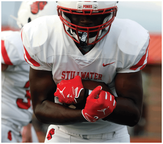 Two people wearing white sports uniforms and red gloves are engaged in a close physical interaction, possibly during a sports event. Description generated by AI
