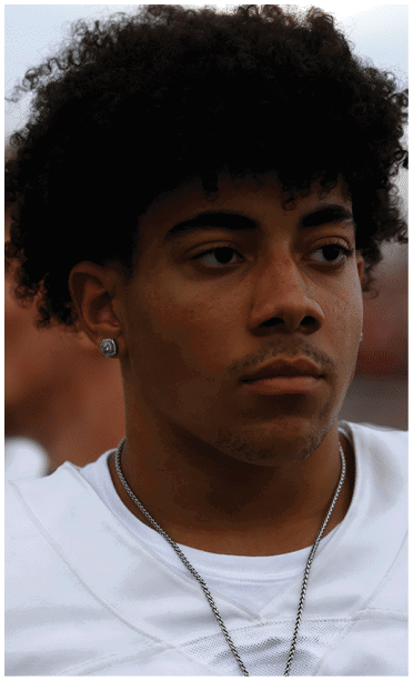 A close-up of a person with curly hair showing one eye and part of the forehead and ear. Description generated by AI
