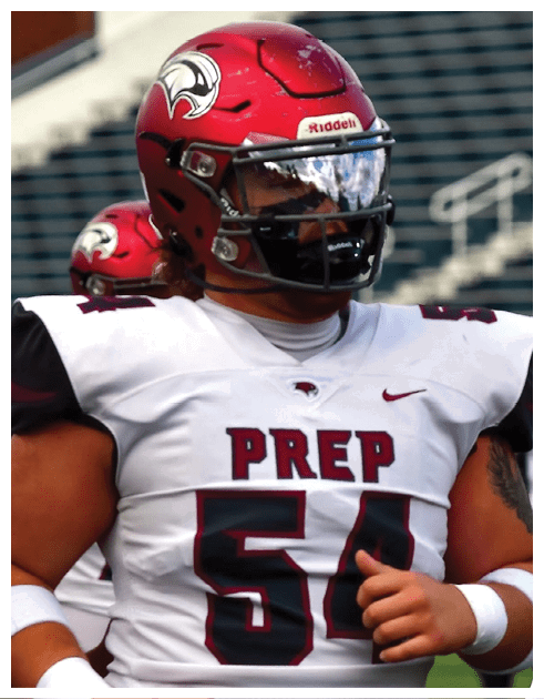 A person wearing a red football helmet and a white jersey with the word “PREP" and the number 54 is standing on a football field. Description generated by AI