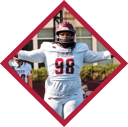 A person wearing a red helmet is partially visible below a digital scoreboard displaying the number 40 in an outdoor setting with a building in the background. Description generated by AI