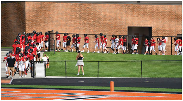 A football game is being played on a field. Description generated by AI