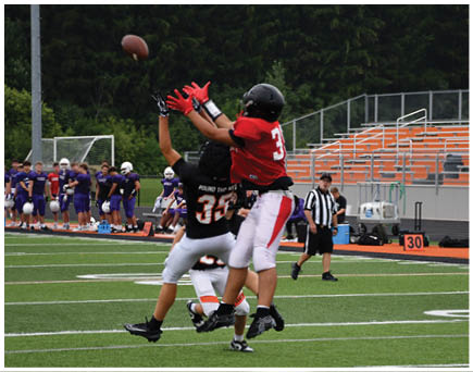 A football game is being played on a field. Description generated by AI
