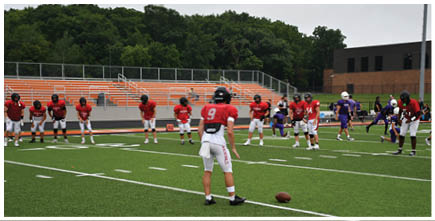 A football game is being played on a field. Description generated by AI