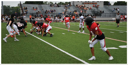 A football game is being played on a field. Description generated by AI