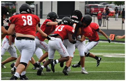 A football game is being played on a field. Description generated by AI