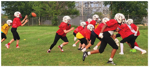 A football player catching a ball. Description generated by AI