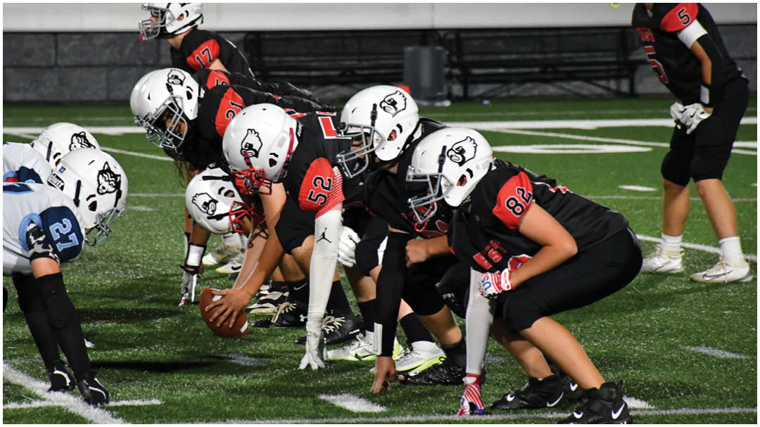 A football game is being played on a field. Description generated by AI