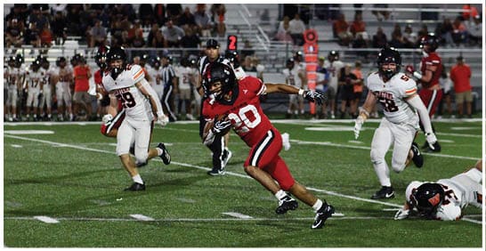 A football player running on the field. Description generated by AI