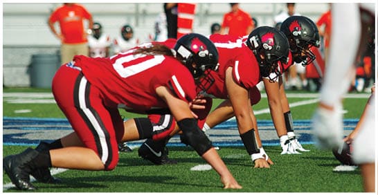 A football player running on the field. Description generated by AI