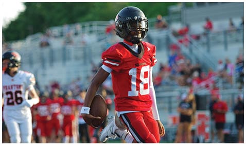 A football player running on the field. Description generated by AI