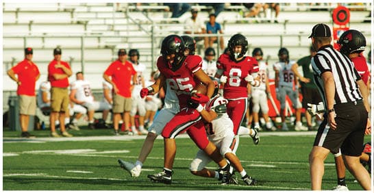 A football player running on the field. Description generated by AI