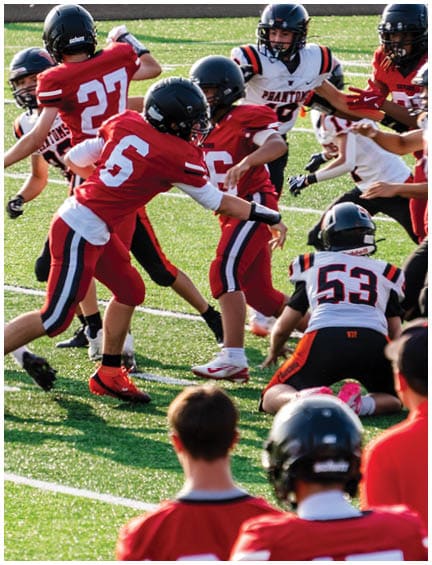 A football player running on the field. Description generated by AI