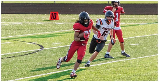 A football player running on the field. Description generated by AI