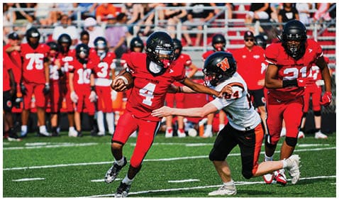 A football player running on the field. Description generated by AI