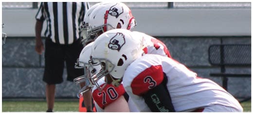 A football player catching a ball. Description generated by AI