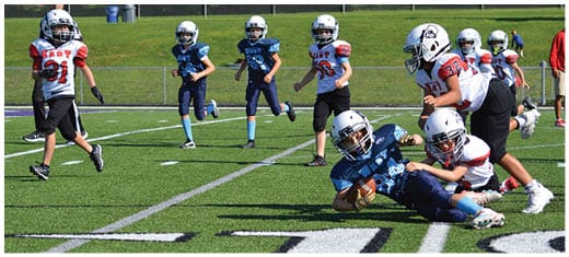 A football player catching a ball. Description generated by AI