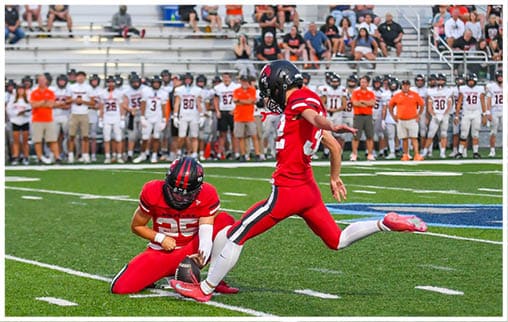 A football player running on the field. Description generated by AI