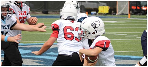 A football player catching a ball. Description generated by AI