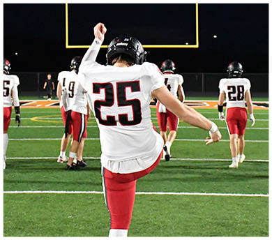 A football player running on the field. Description generated by AI