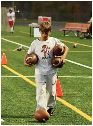 A football player wearing a blue and red jersey. Description generated by AI
