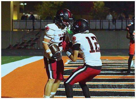 A football player wearing a blue and red jersey. Description generated by AI