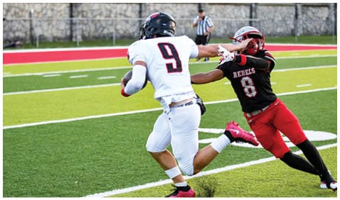 A football player running on the field. Description generated by AI