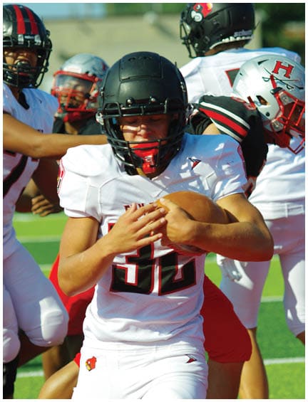 A football player running on the field. Description generated by AI