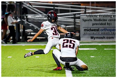 A football player running on the field. Description generated by AI