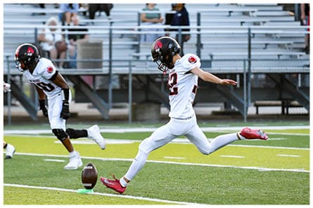 A football player running on the field. Description generated by AI