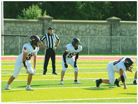 A football player wearing a blue jersey with the number 58 on it. Description generated by AI