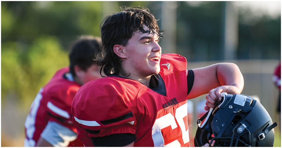 A football player wearing a blue jersey with the number 58 on it. Description generated by AI