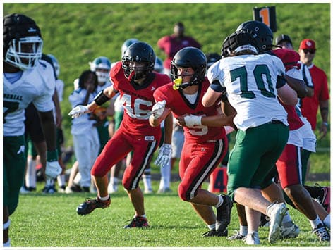 A football player wearing a blue jersey with the number 58 on it. Description generated by AI